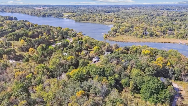 birds eye view of property with a water view and a wooded view