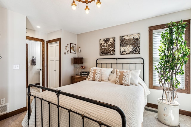 bedroom with carpet floors, visible vents, baseboards, and a notable chandelier