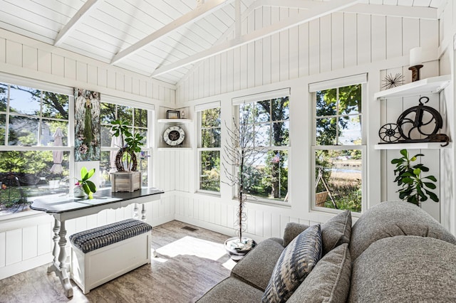 sunroom / solarium with vaulted ceiling with beams, radiator heating unit, and visible vents