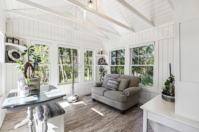 sunroom featuring vaulted ceiling with beams