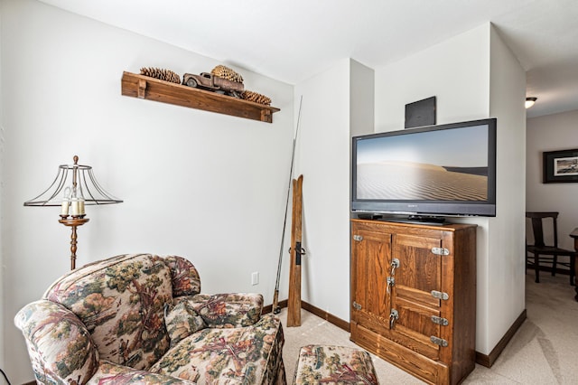 sitting room with carpet flooring and baseboards