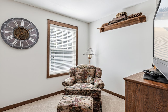 living area with light colored carpet and baseboards