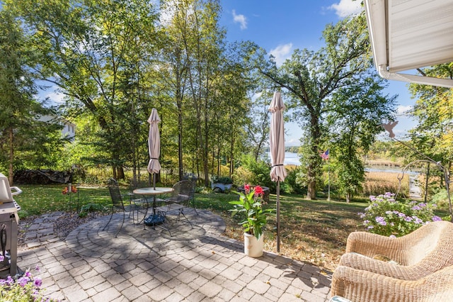 view of patio with outdoor dining space and a water view