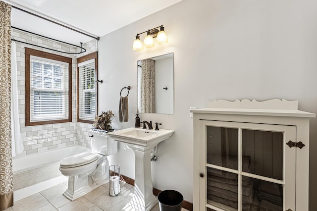 full bath with a sink, tile patterned flooring, toilet, and shower / bathtub combination with curtain