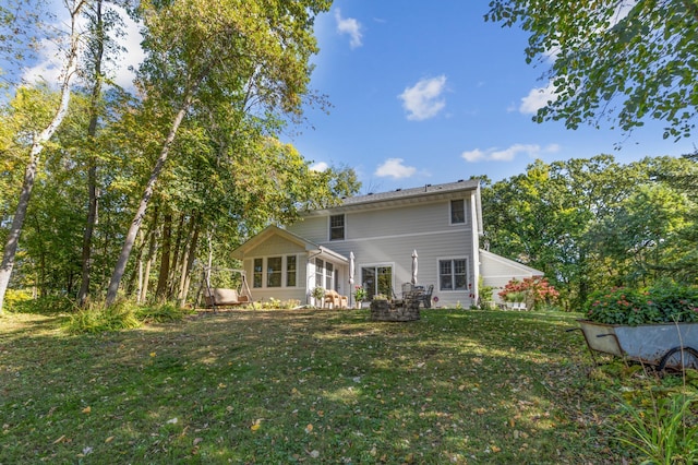 rear view of property with a lawn