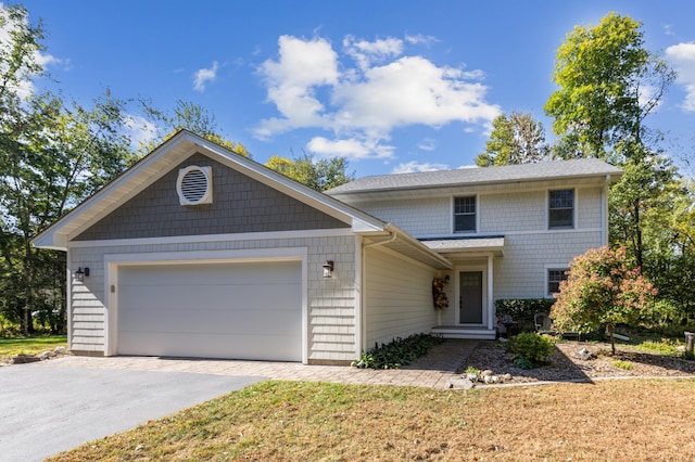 traditional-style home with a garage and aphalt driveway