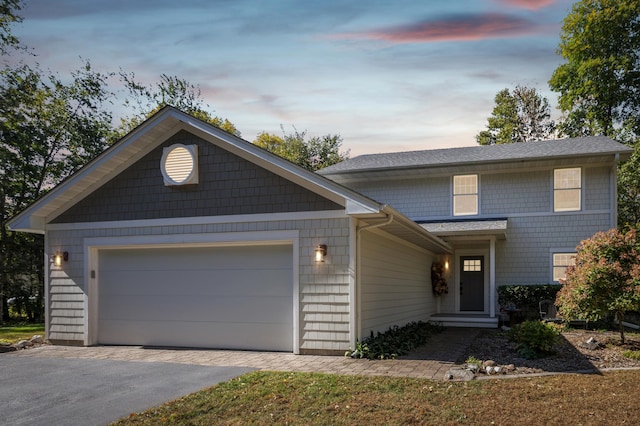 traditional-style house featuring aphalt driveway and a garage