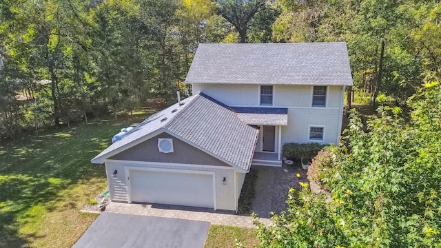 28342 Tiger St NW, Zimmerman, MN 55398 - traditional-style home with a front yard, a shingled roof, a garage, driveway, and a wooded view