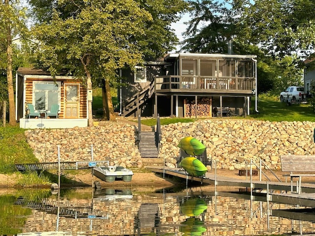 rear view of house featuring a sunroom