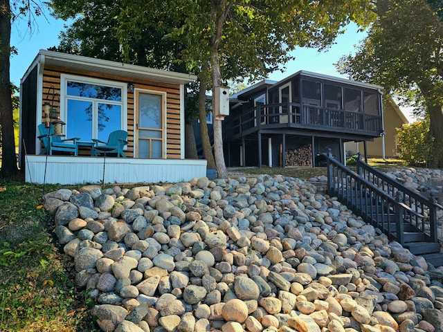 exterior space featuring a sunroom and a deck