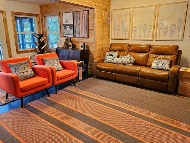 living room featuring hardwood / wood-style flooring and wooden walls