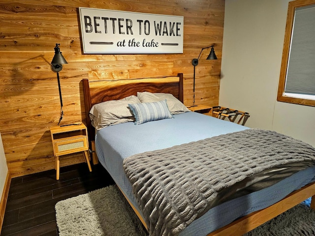 bedroom featuring wood walls and dark wood-type flooring