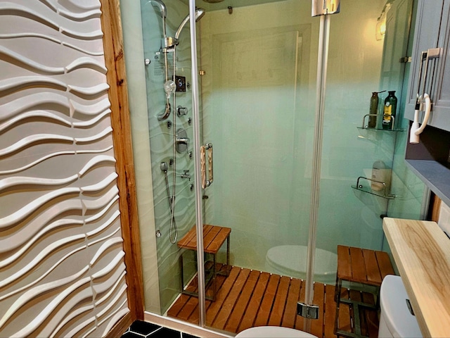 bathroom with tile patterned flooring, toilet, and an enclosed shower