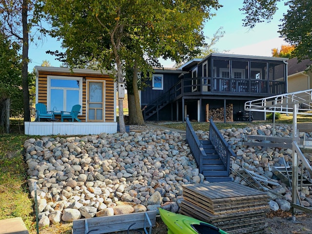 back of house featuring a sunroom