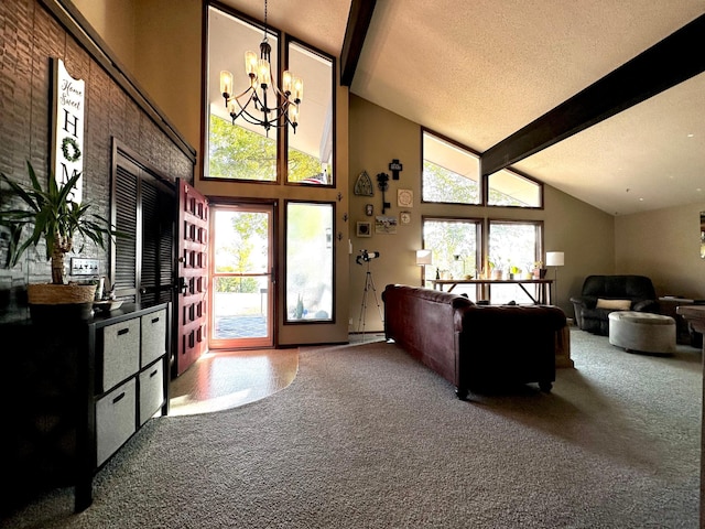 carpeted living room with high vaulted ceiling, beamed ceiling, a textured ceiling, and a chandelier