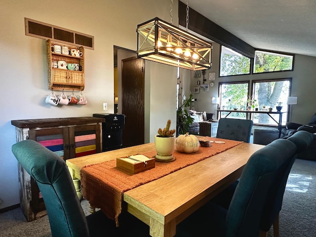 dining area featuring carpet flooring and vaulted ceiling with beams