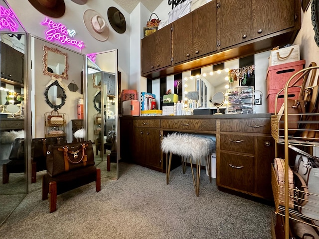 kitchen with dark brown cabinetry and carpet floors