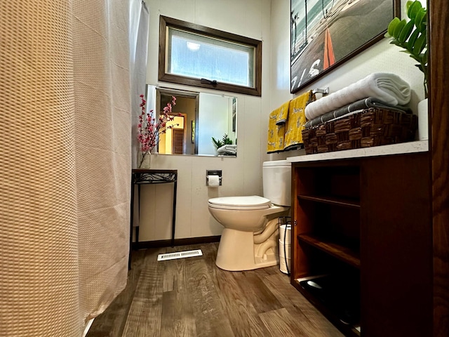 bathroom featuring hardwood / wood-style floors and toilet