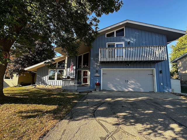 view of front of property with a balcony and a front lawn