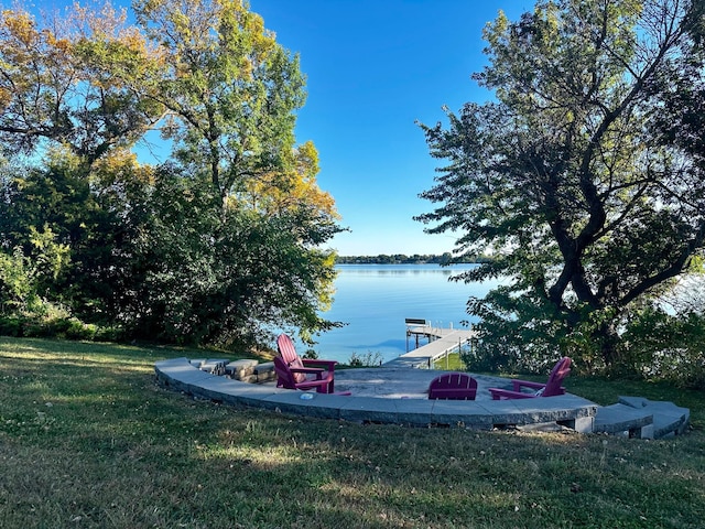 view of yard featuring a dock and a water view