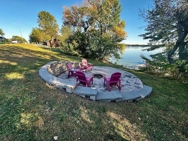 view of yard with a patio, an outdoor fire pit, and a water view