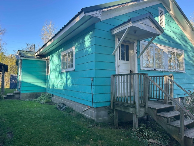 view of side of property featuring a deck and a yard