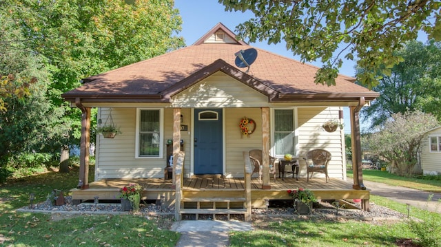 bungalow-style house featuring a porch and a front lawn