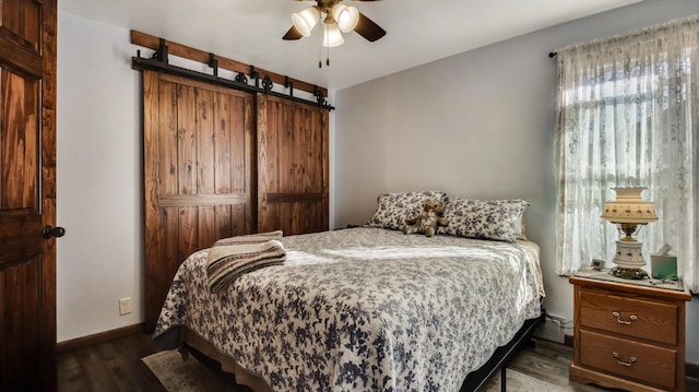 bedroom featuring a ceiling fan, baseboards, and dark wood-style flooring