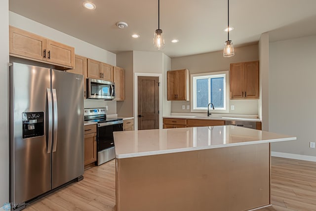 kitchen with light wood-type flooring, a center island, and appliances with stainless steel finishes