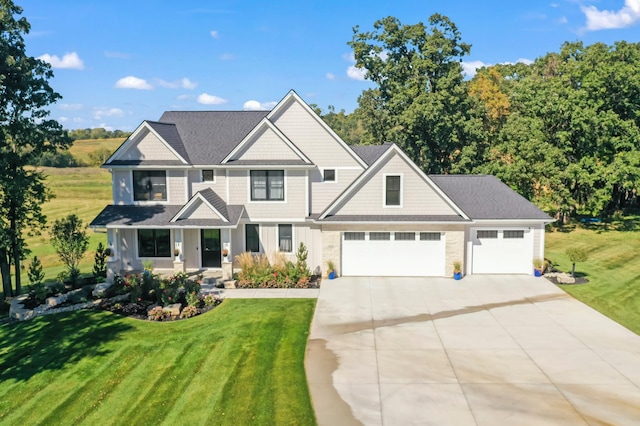 view of front of property featuring a front lawn and a garage