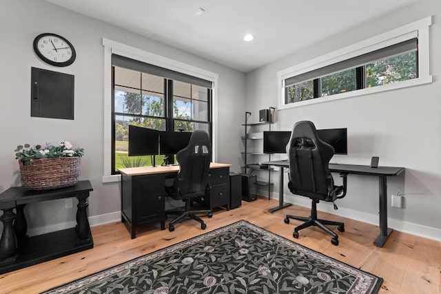 office featuring light hardwood / wood-style flooring and electric panel