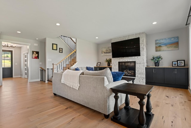 living room with a fireplace and light hardwood / wood-style flooring