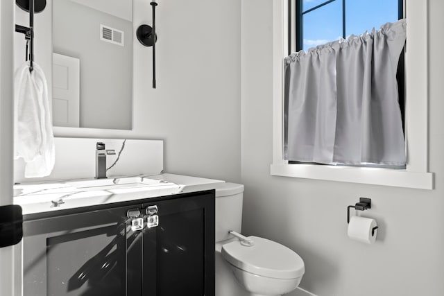 bathroom featuring vanity and toilet