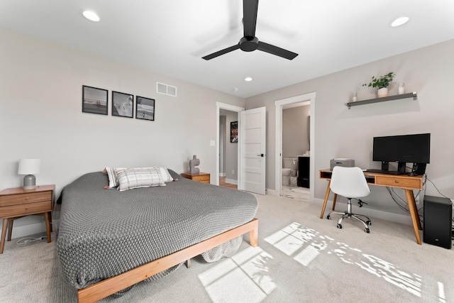 carpeted bedroom with ceiling fan and connected bathroom