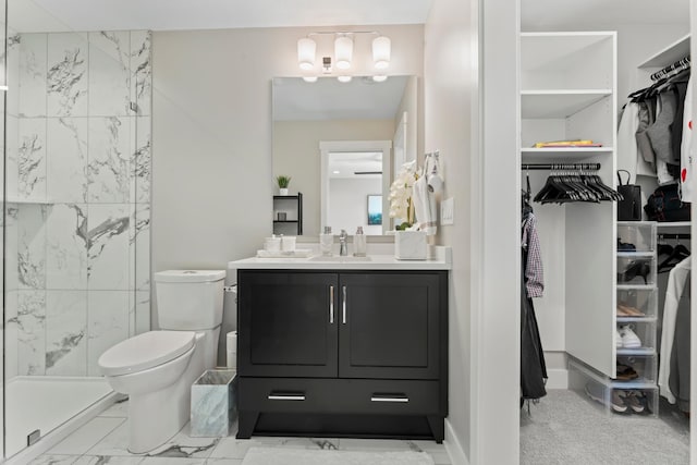 bathroom featuring vanity, toilet, and an enclosed shower