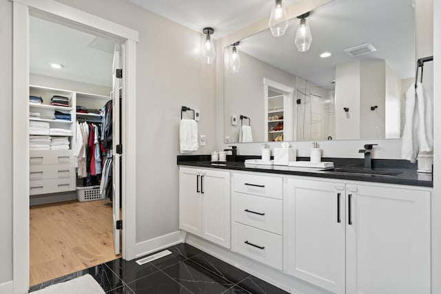 bathroom with hardwood / wood-style floors, an enclosed shower, and vanity