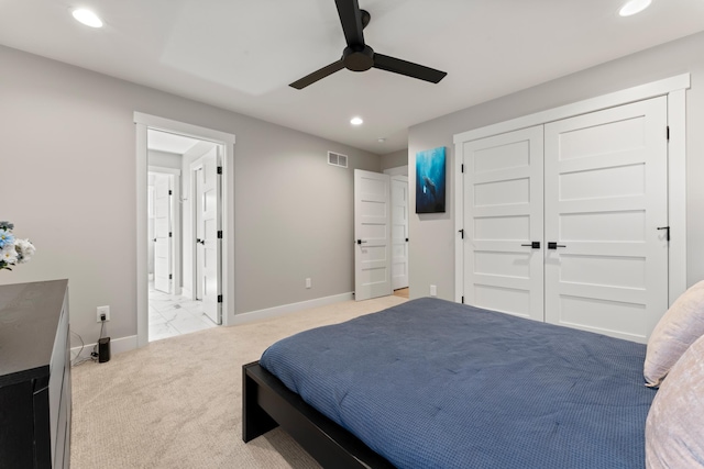 carpeted bedroom with ceiling fan and a closet