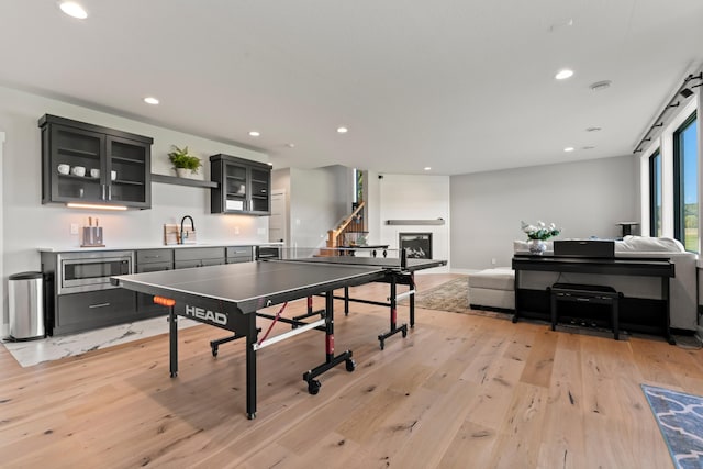 playroom featuring sink and light hardwood / wood-style flooring