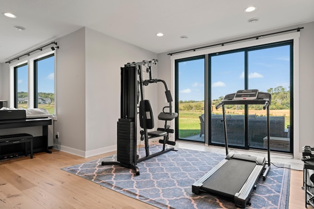 exercise area with light hardwood / wood-style floors