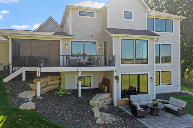 back of house featuring a sunroom, an outdoor hangout area, and a patio area