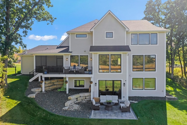 rear view of property with a yard and a patio area