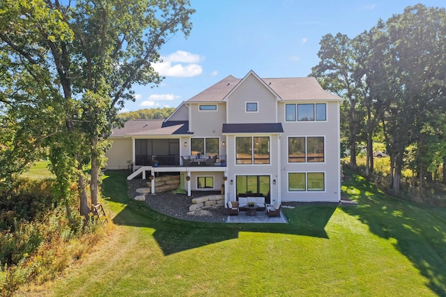 back of property with a yard, outdoor lounge area, and a patio area