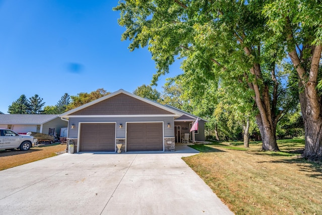 view of front of property with a front yard and a garage