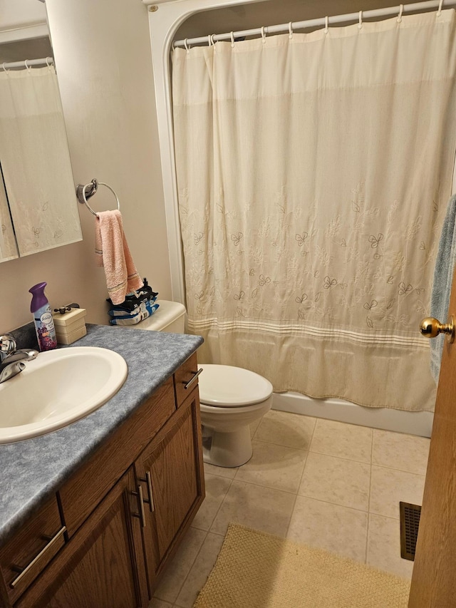 full bathroom featuring vanity, toilet, tile patterned floors, and shower / bath combo with shower curtain