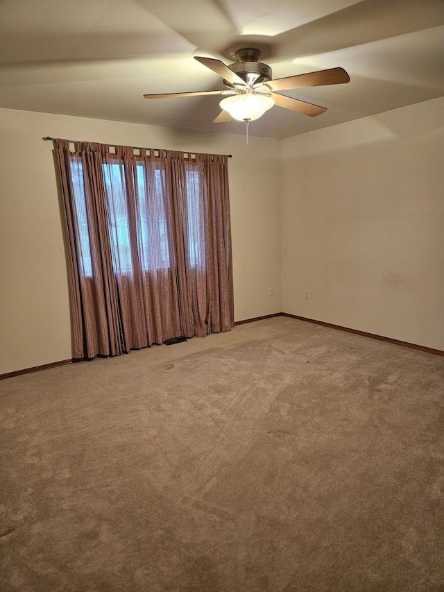 carpeted empty room featuring ceiling fan