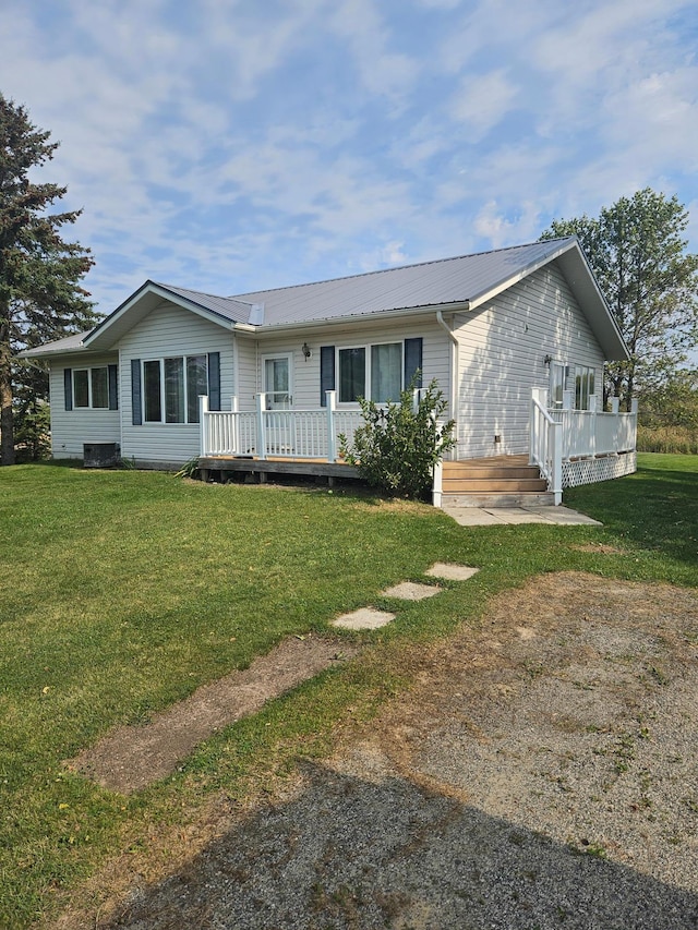 single story home featuring a front yard and a wooden deck