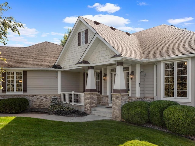 view of front of home featuring a front yard and a porch