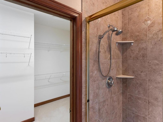 bathroom featuring a shower with shower door