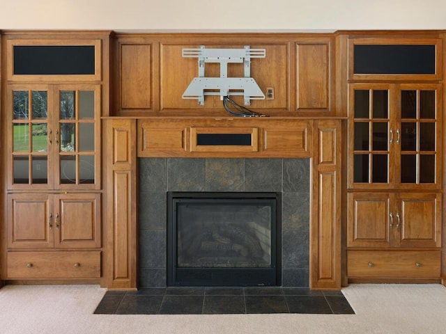 details featuring a tile fireplace and carpet floors