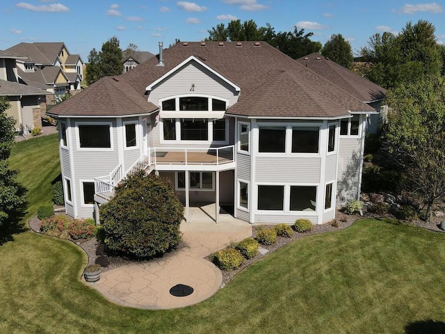 back of property with a patio and a yard